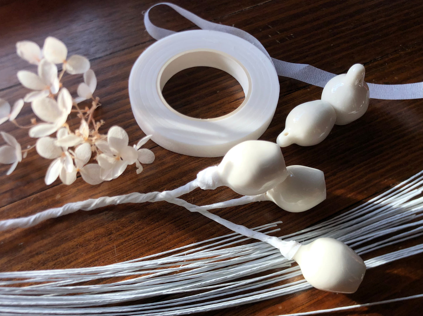 Porcelain gumnuts, secured with florist tape and wires, arranged in a beautiful floral display that celebrates Australian native charm. The gumnuts add a touch of rustic elegance to the arrangement, blending seamlessly with other botanical elements.