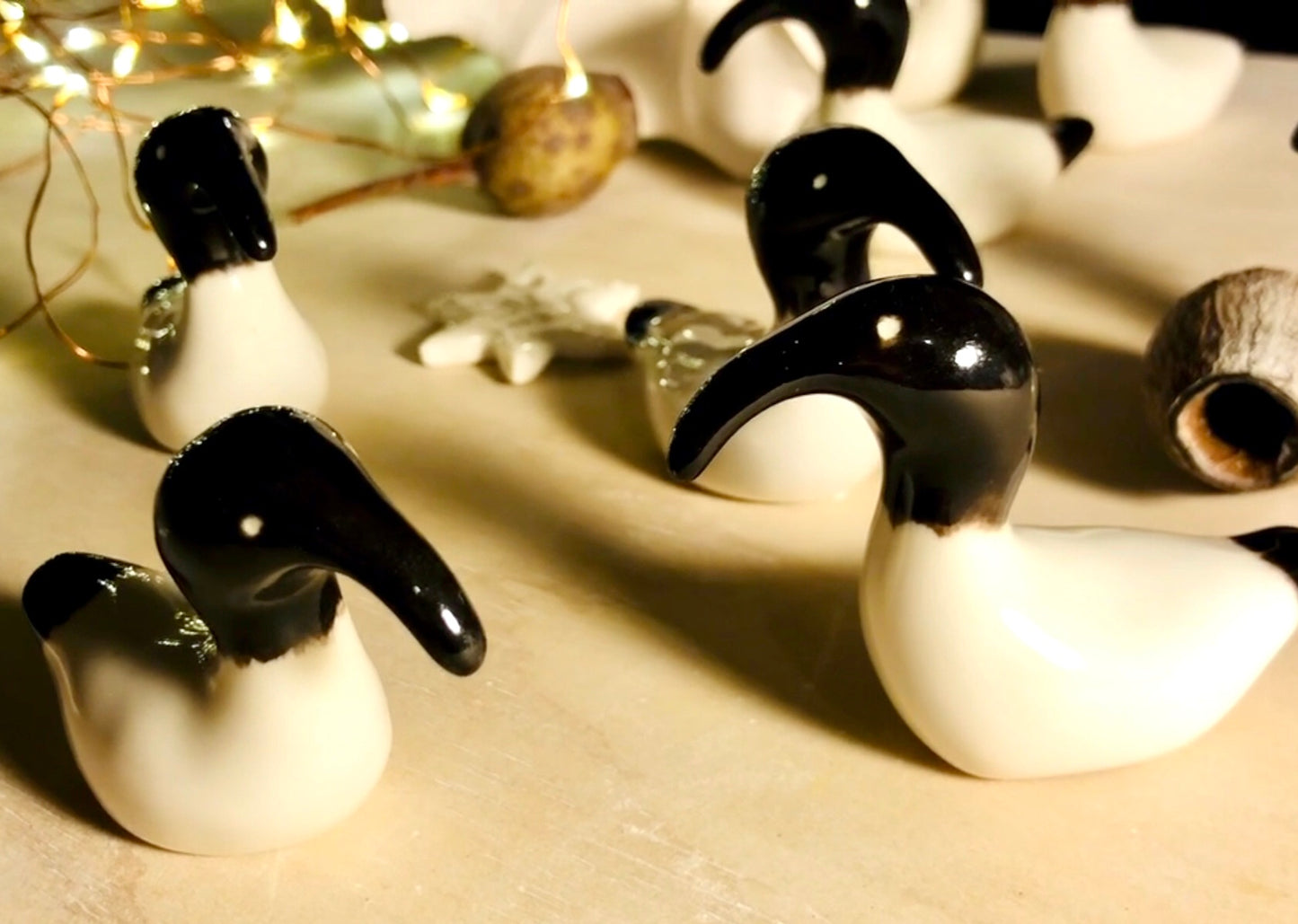 Artistic depiction of a group of Australian White Ibises, known as 'bin chickens,' with black beaks, celebrating Christmas by creatively weaving themselves into a dazzling array of holiday lights.