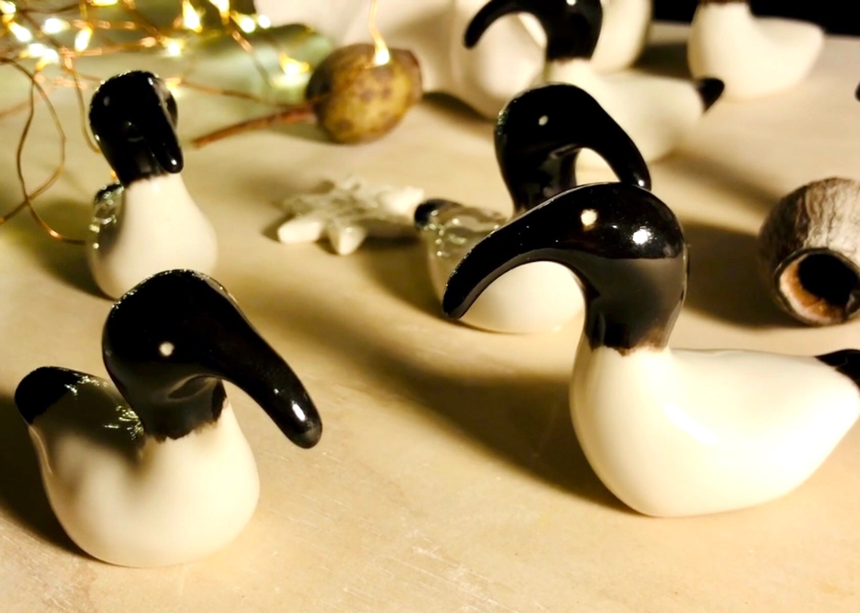 Artistic depiction of a group of Australian White Ibises, known as 'bin chickens,' with black beaks, celebrating Christmas by creatively weaving themselves into a dazzling array of holiday lights.