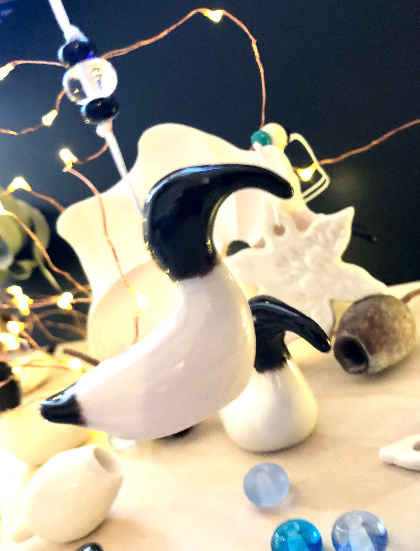 Bin chicken ceramic ornament, made from porcelain and handcrafted with care, placed among Christmas decorations and gum nuts, showcasing the beauty of Australian wildlife in a festive setting.