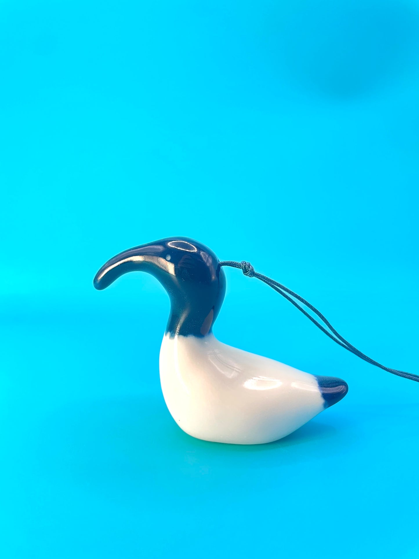 Ceramic decoration of an Australian White Ibis, commonly known as a 'bin chicken,' featuring its distinctive white plumage, featherless black head and neck, and long downcurved blue beak. 