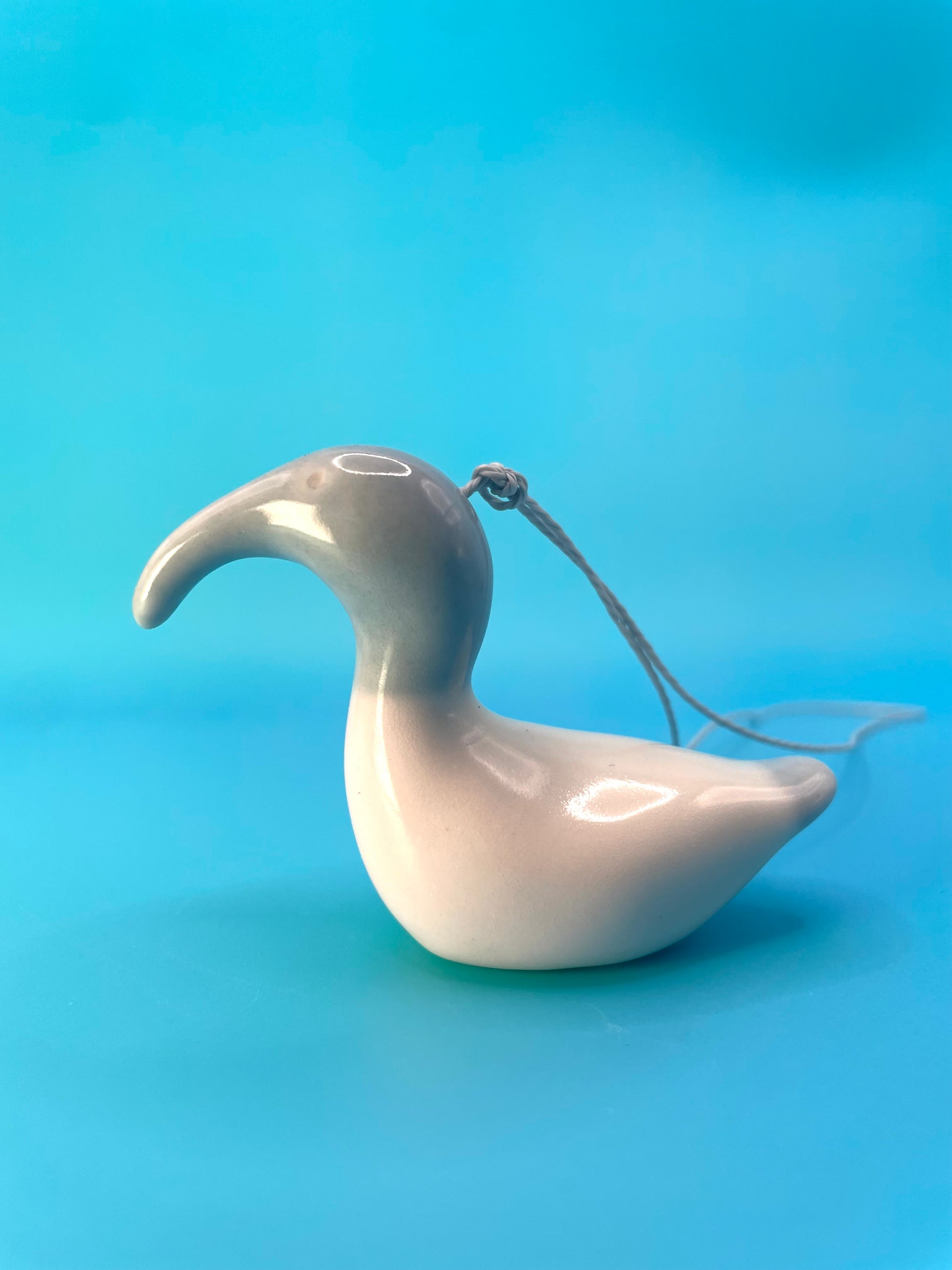 Grey ceramic representation of the Australian White Ibis, highlighting its iconic features such as the elongated beak and sleek design.