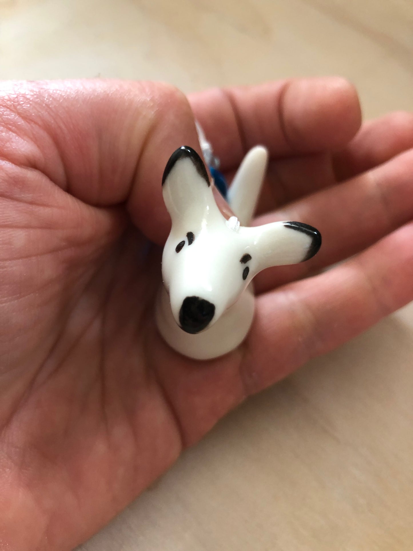 Top view of a ceramic kangaroo ornament, held in a person's hand, highlighting its size and the intricate details of its design, perfect for those who appreciate handmade decorations