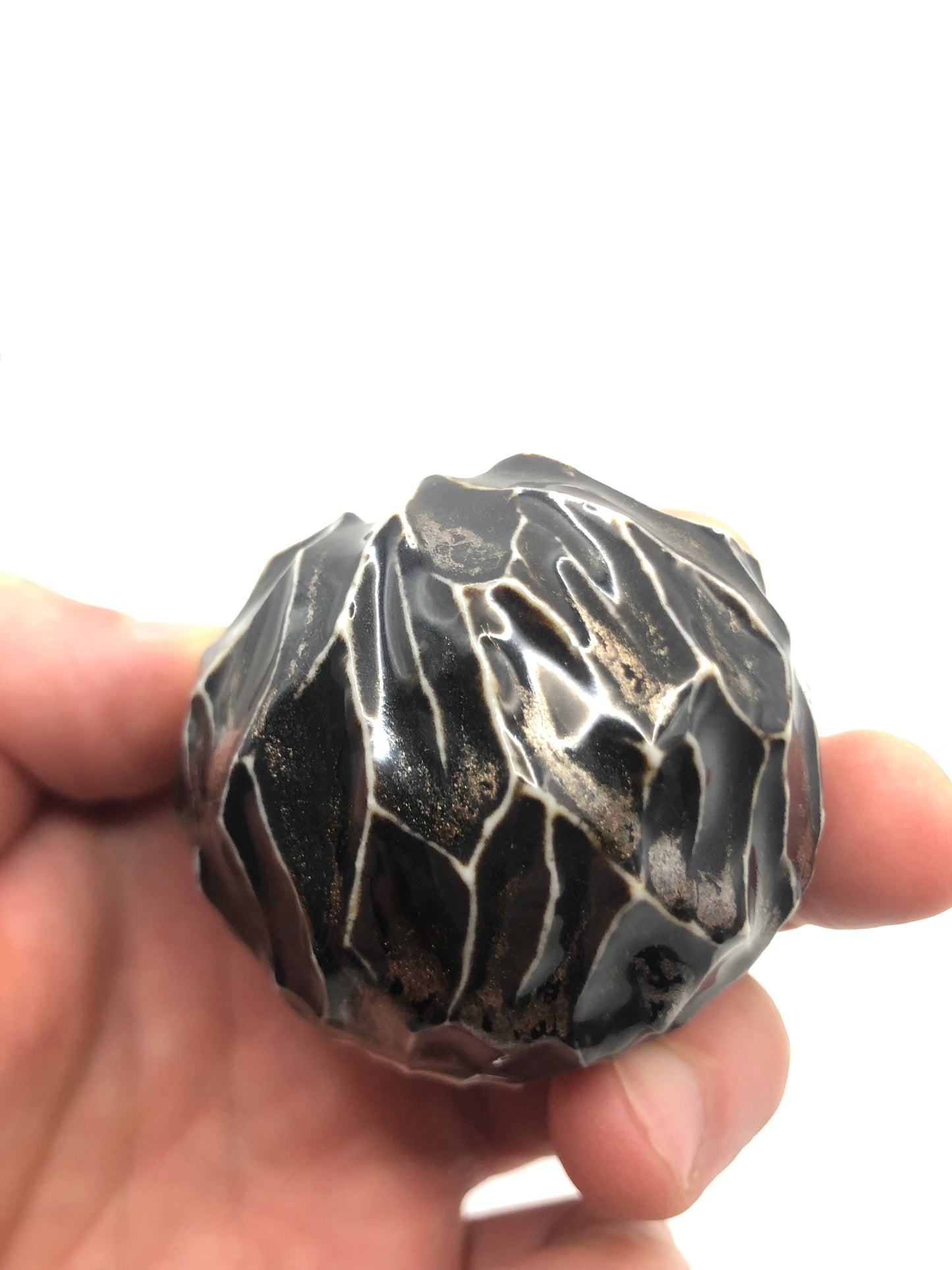 Handheld black aventurine round porcelain vase, featuring a stunning aventurine glaze and a smooth, rounded form, highlighting the vase's beauty and the skilful craftsmanship involved.