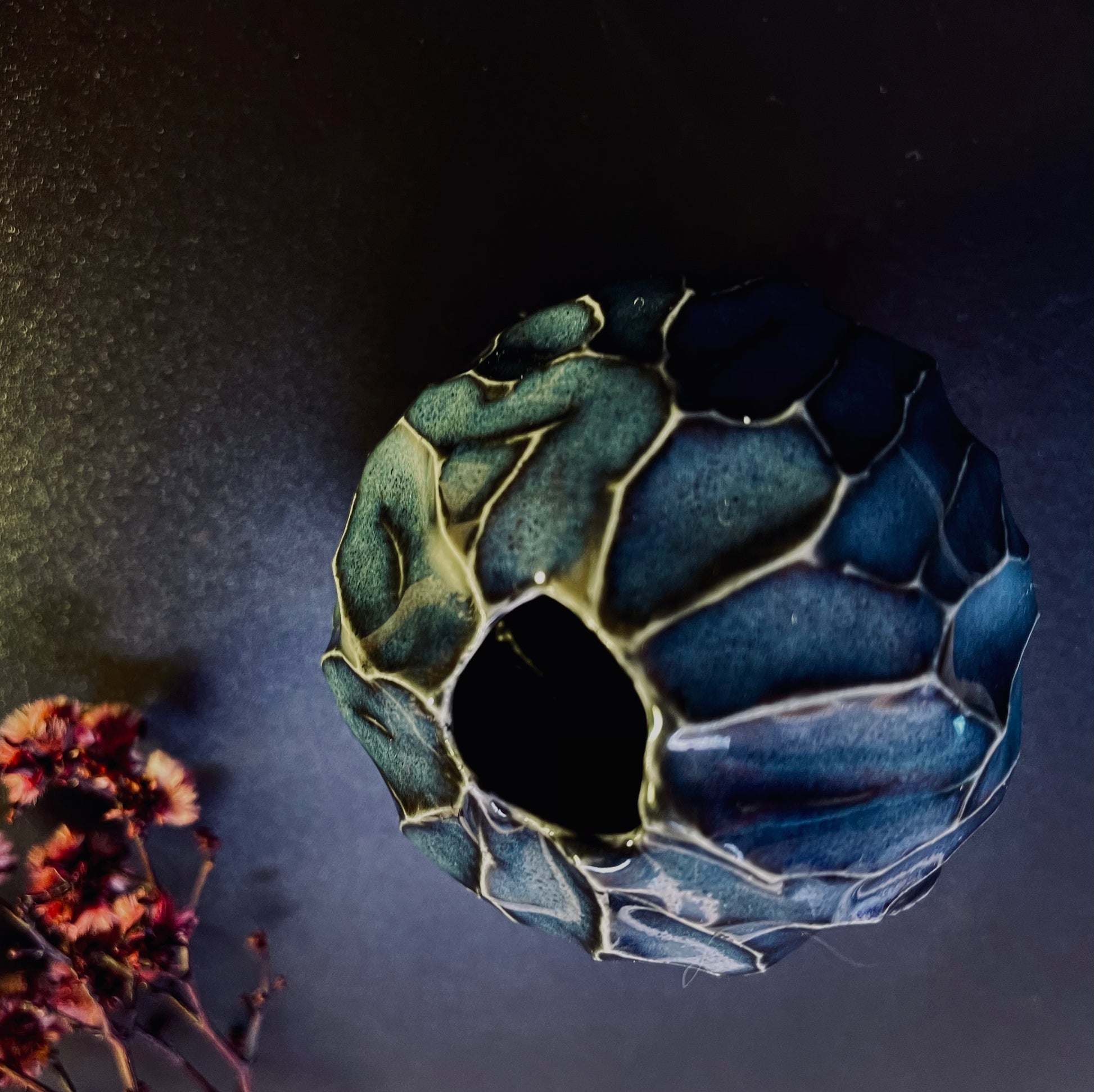 Midnight blue porcelain vase with a rounded silhouette, featuring a rich, dark blue colour that adds a sophisticated touch to any setting.