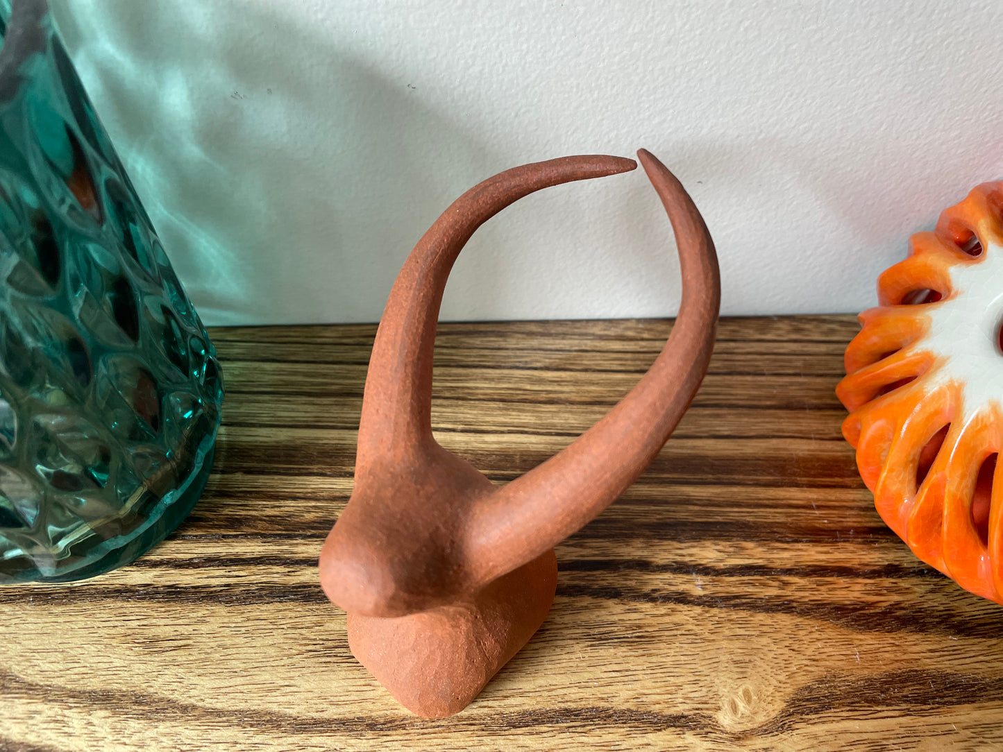 Hand-carved yak figurine made from red earth clay, shown from the top, emphasising its natural texture and minimalistic aesthetic, perfect for adding a touch of handmade charm to any space.
