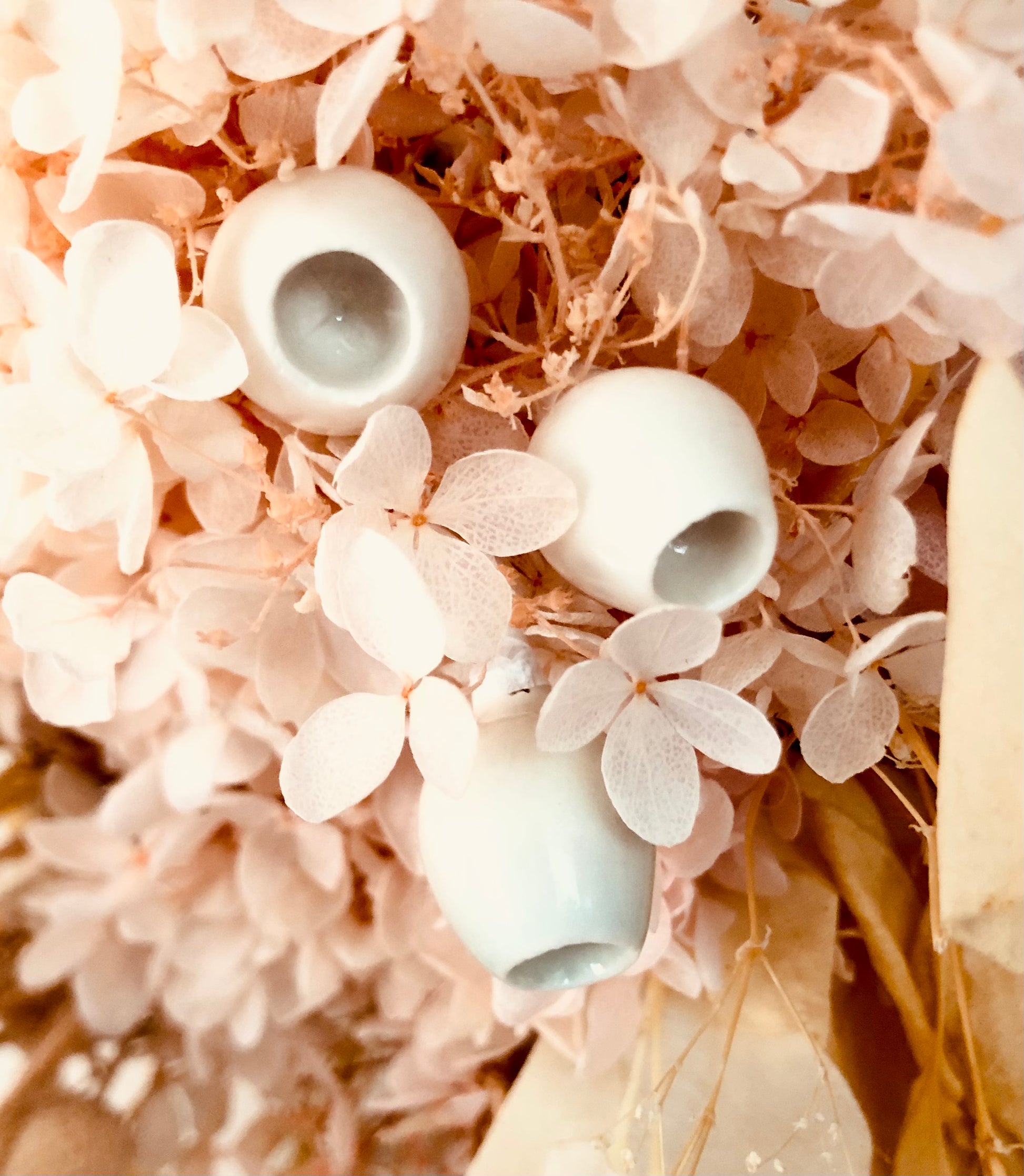 Flower arrangement featuring ceramic gumnuts, which add a touch of Australian charm and native beauty, complementing the lush flowers and foliage in the arrangement.