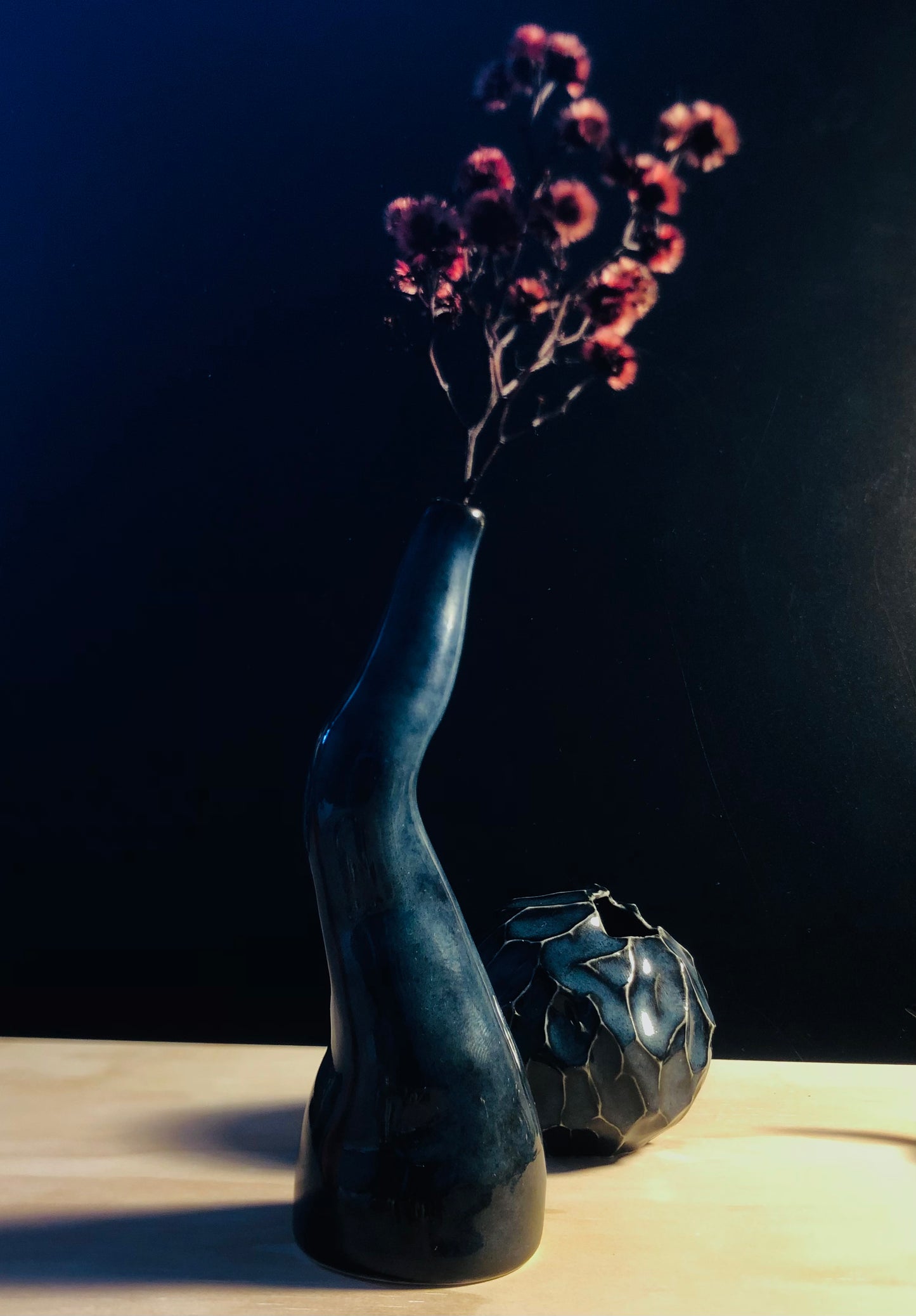 Twisted vase paired with a rounded vase, highlighting the beauty of the vase's curved design and the item's unique qualities, adding a touch of refinement to the setting.